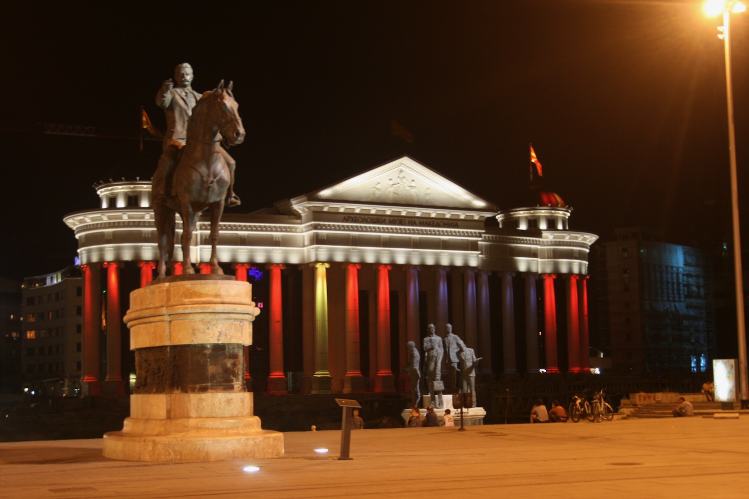 a statue of a man on a horse in front of a building