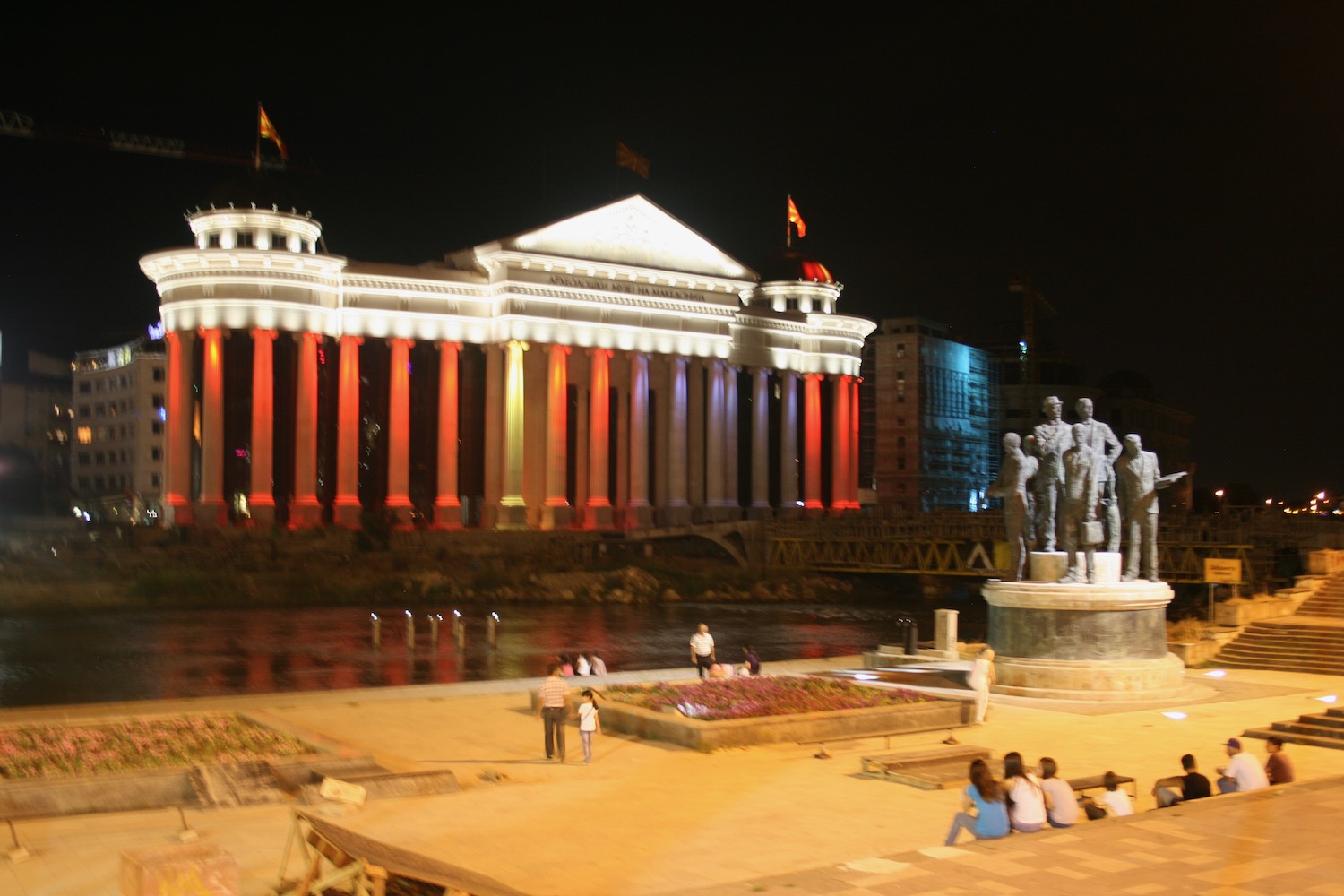 a building with columns and a statue in front of it