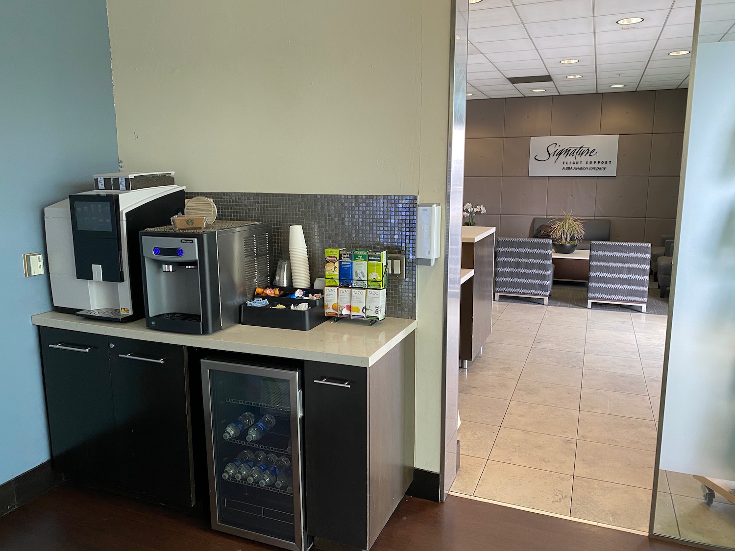 a coffee machine and beverage dispenser in a room