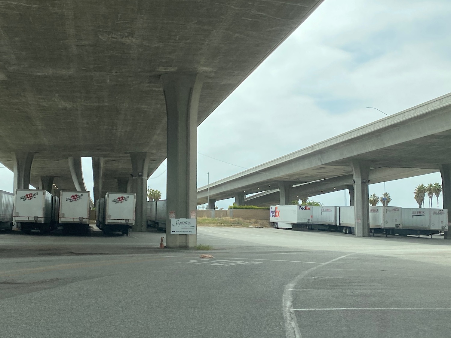 a parking lot with a few semi trucks