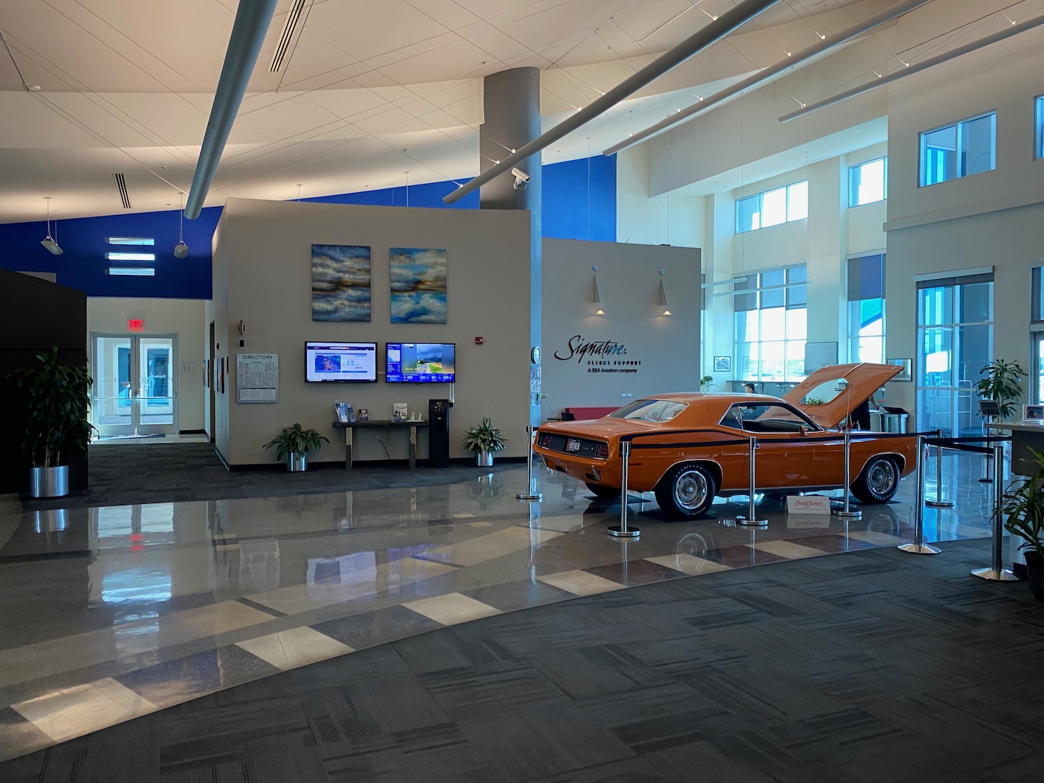 an orange car in a showroom