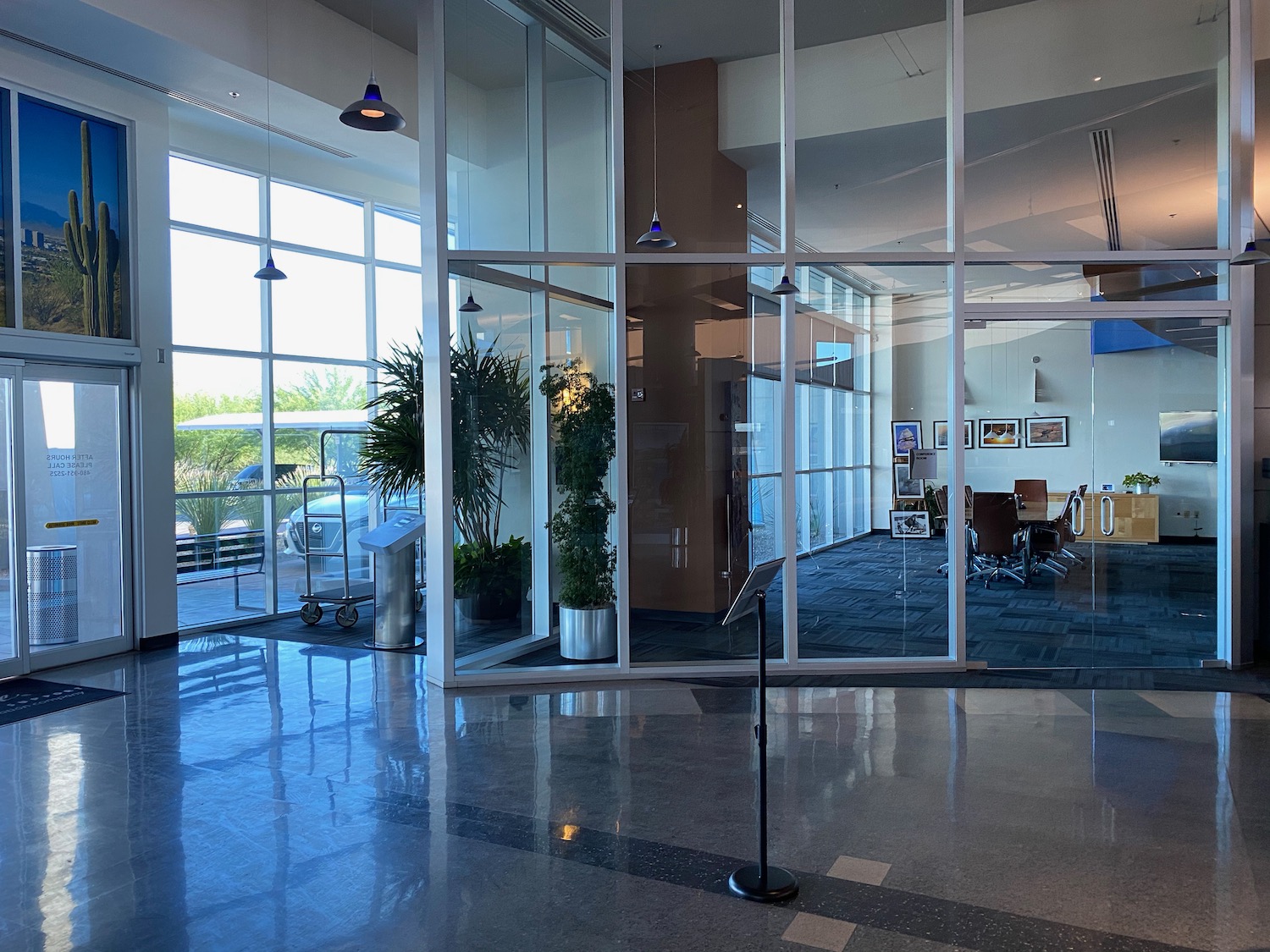 a glass wall with a stand in front of a building