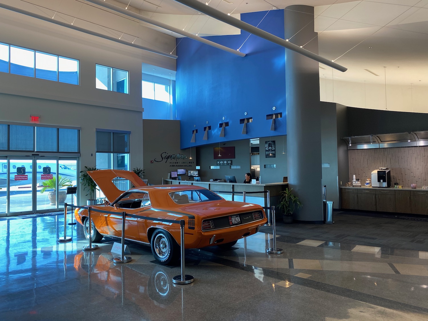 an orange car in a showroom