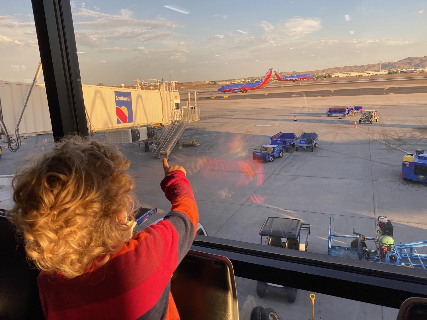 a child pointing at a plane