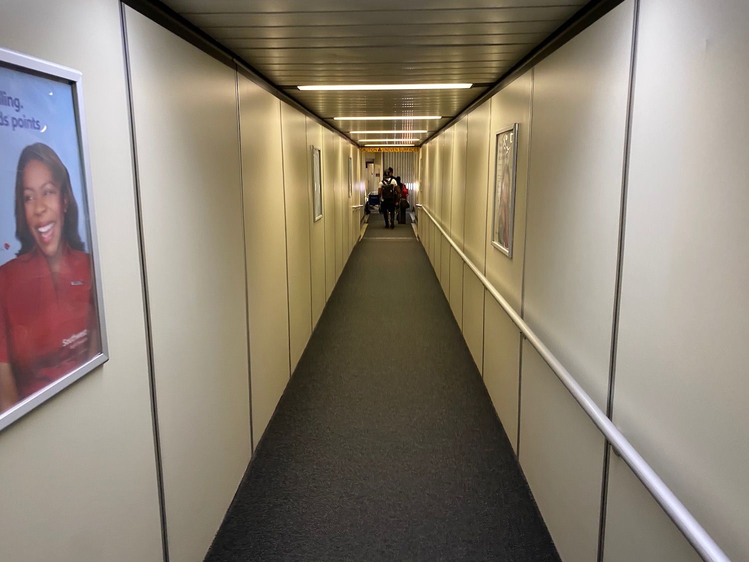 a long hallway with people walking on it