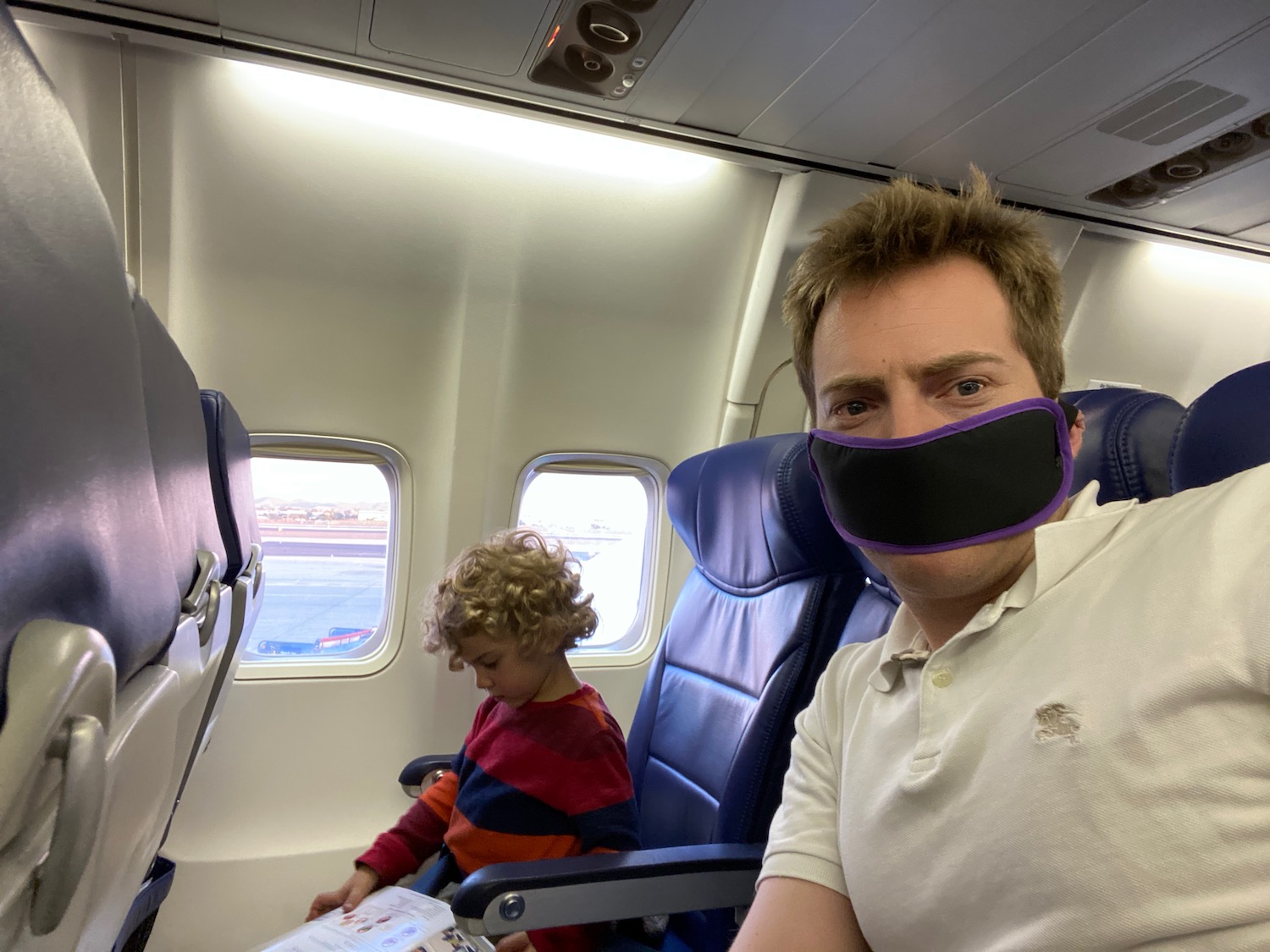 a man and child on an airplane