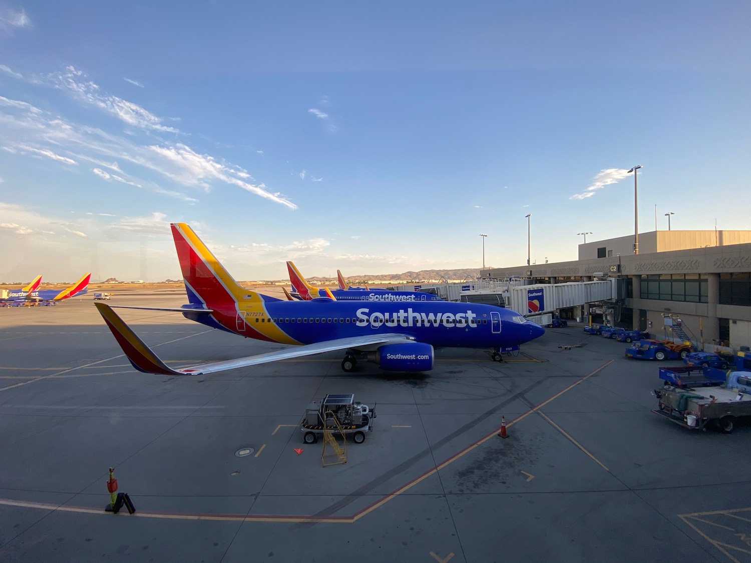 a blue and red airplane at an airport