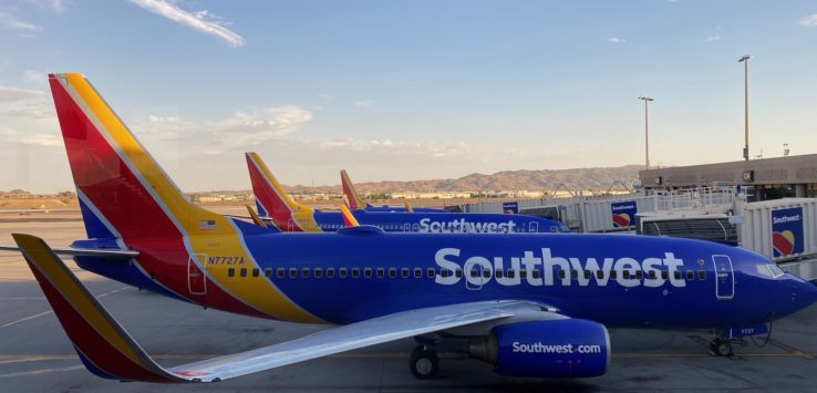 a group of airplanes parked at an airport