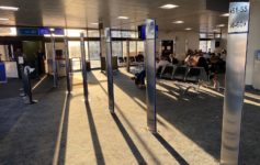 a group of people sitting in an airport terminal