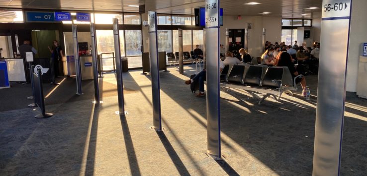 a group of people sitting in an airport terminal