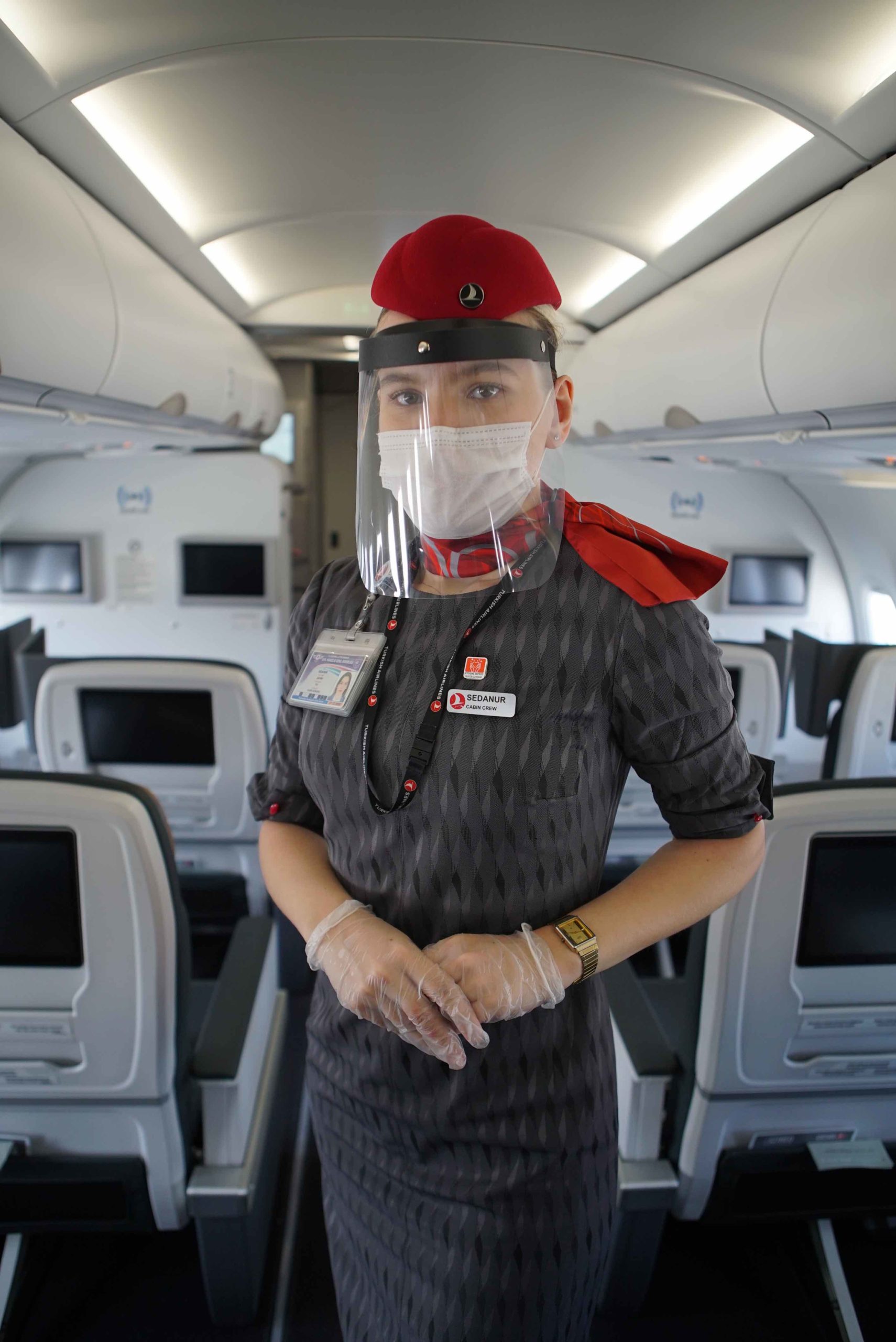 a woman wearing a face shield and gloves