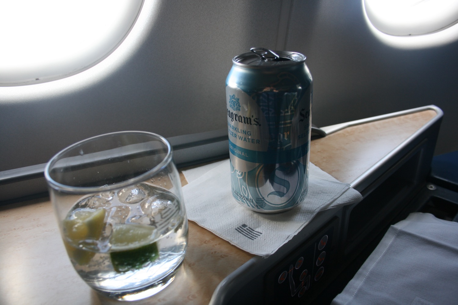 a can of beer and a glass of water on a table