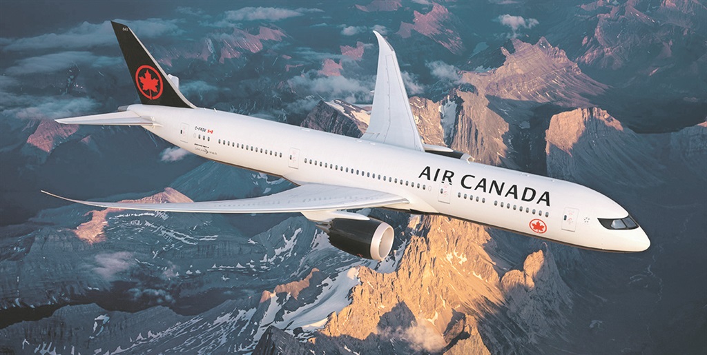 a plane flying over mountains