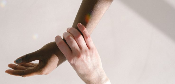 a close-up of a hand holding a person's arm