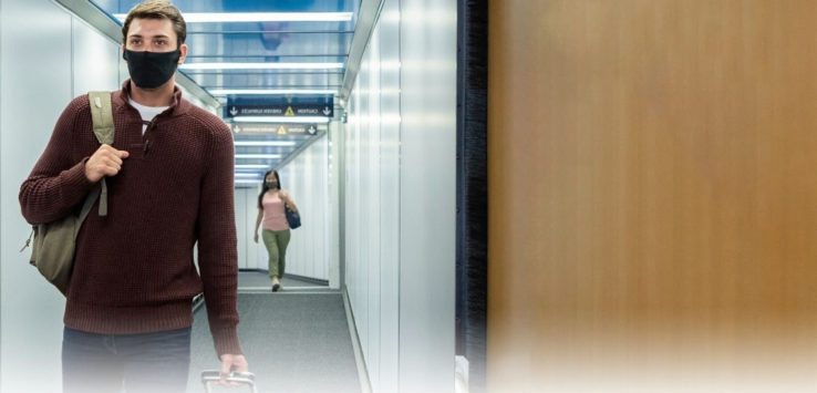 a man and woman walking in a hallway