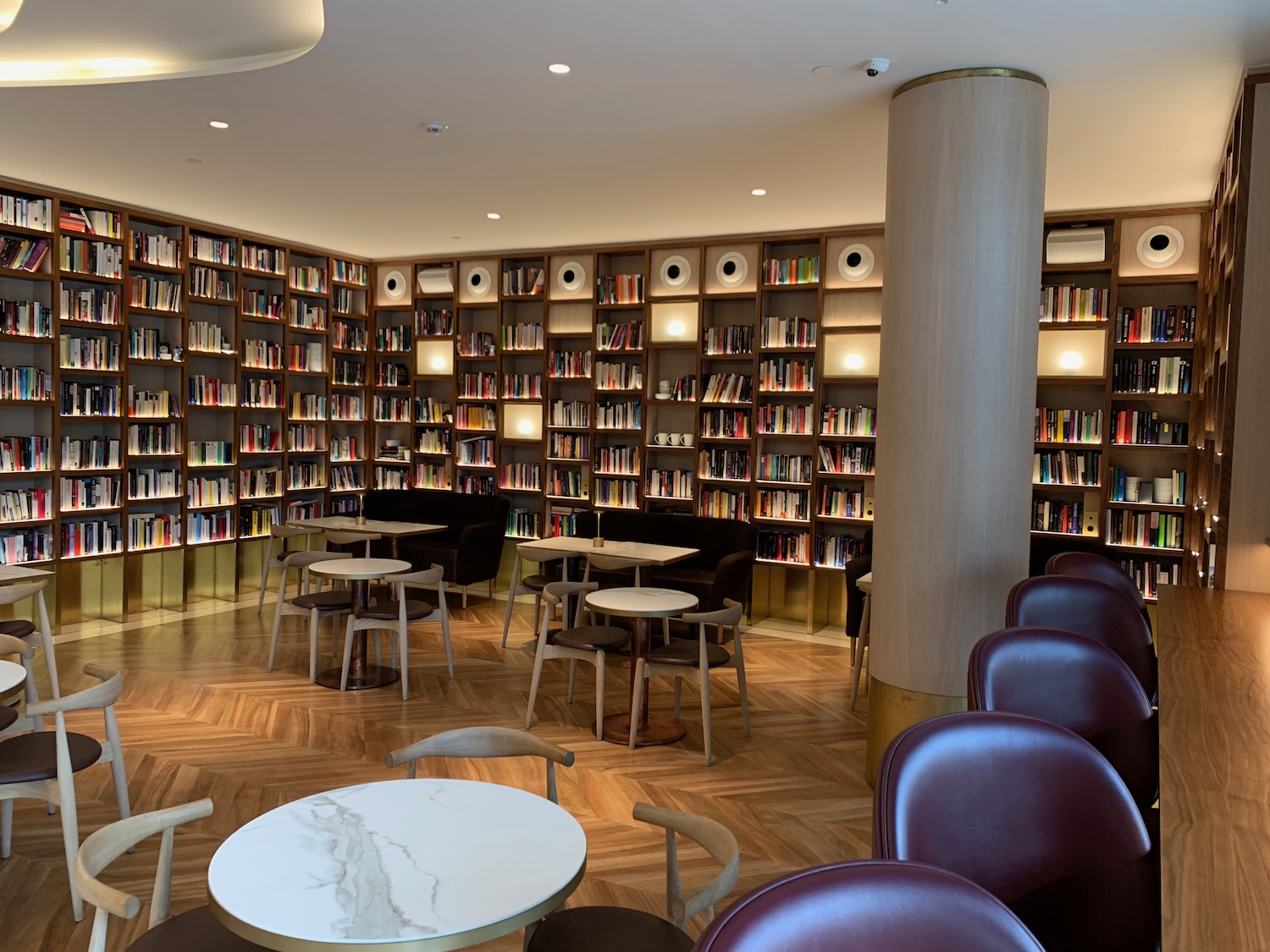 a room with tables and chairs and bookshelves