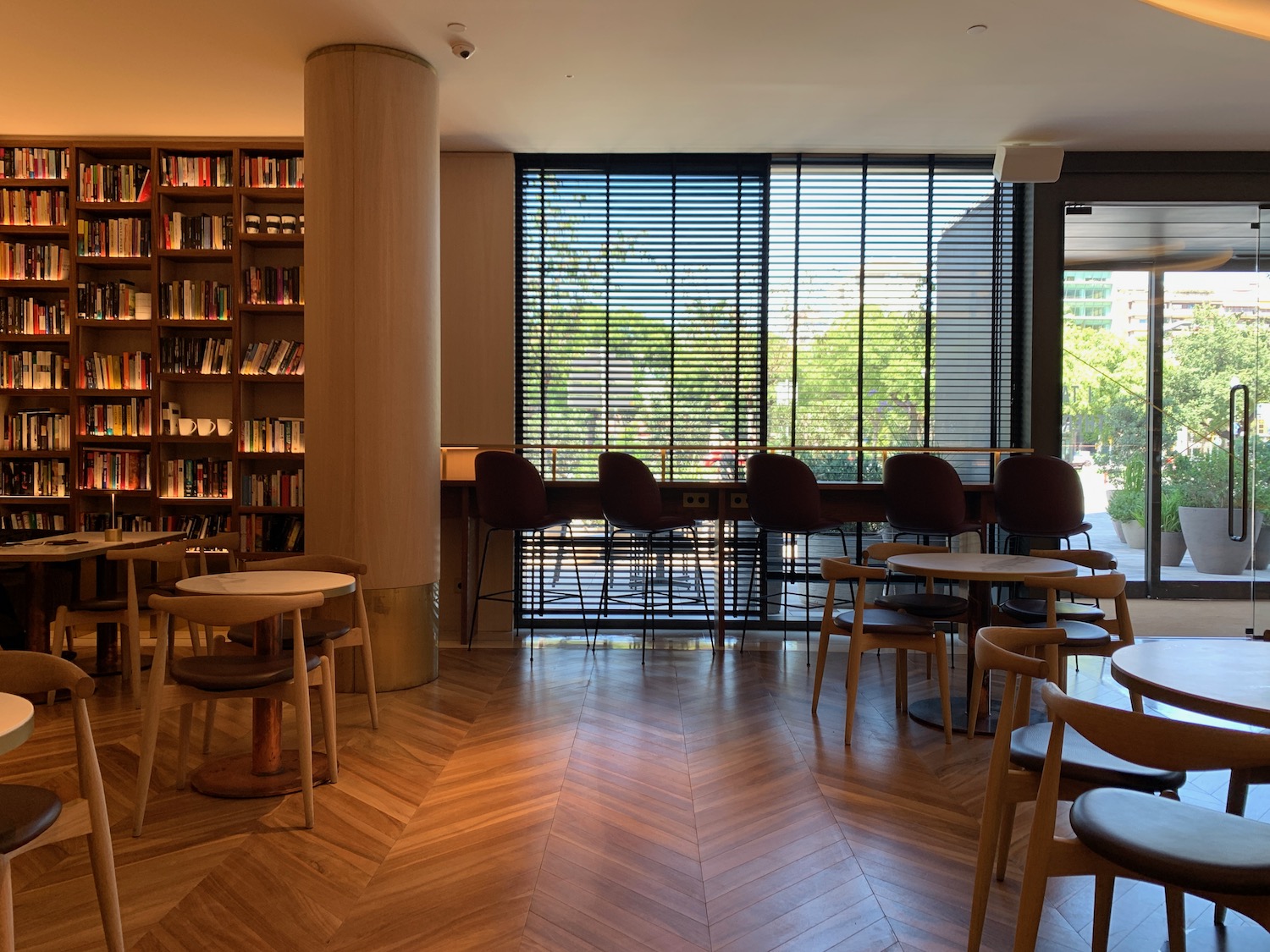 a room with a bookcase and tables