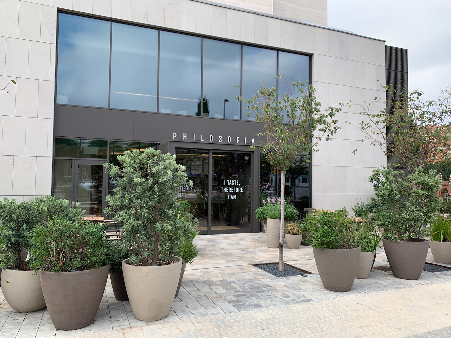 a building with a lot of plants in pots