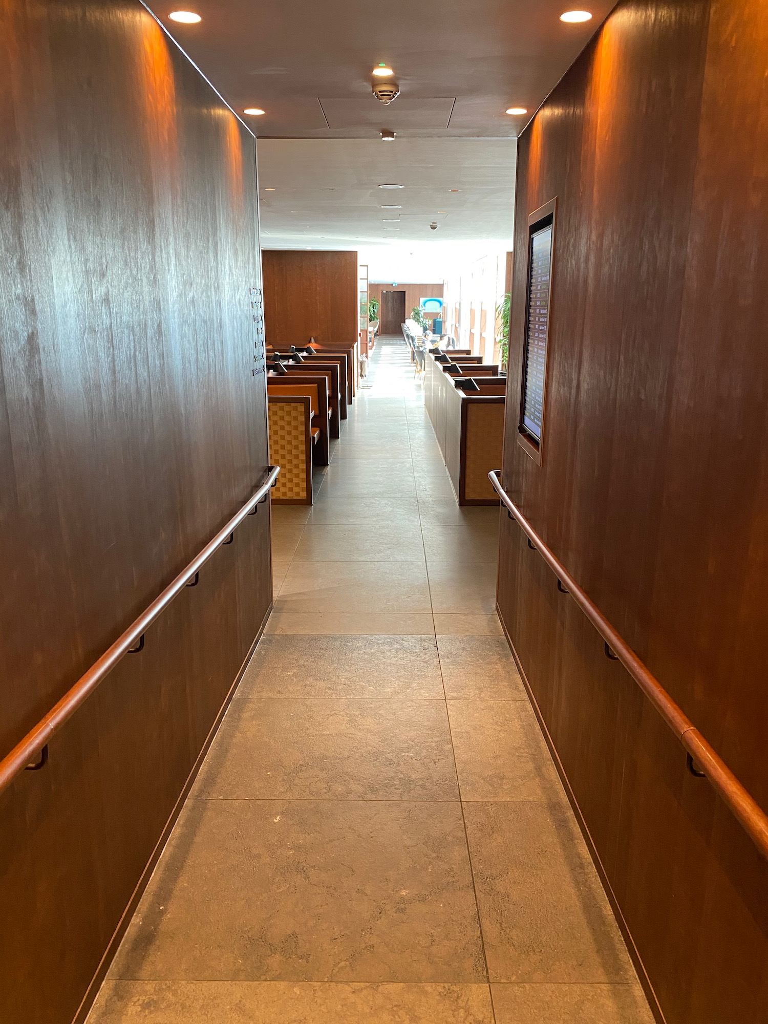 a hallway with benches and tables