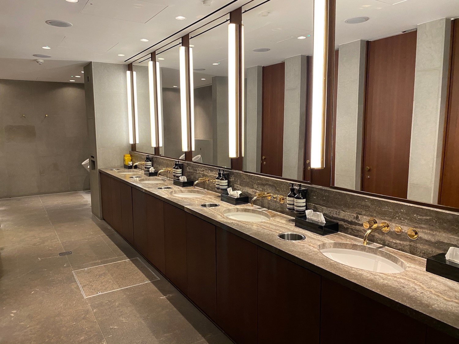 a bathroom with sinks and lights