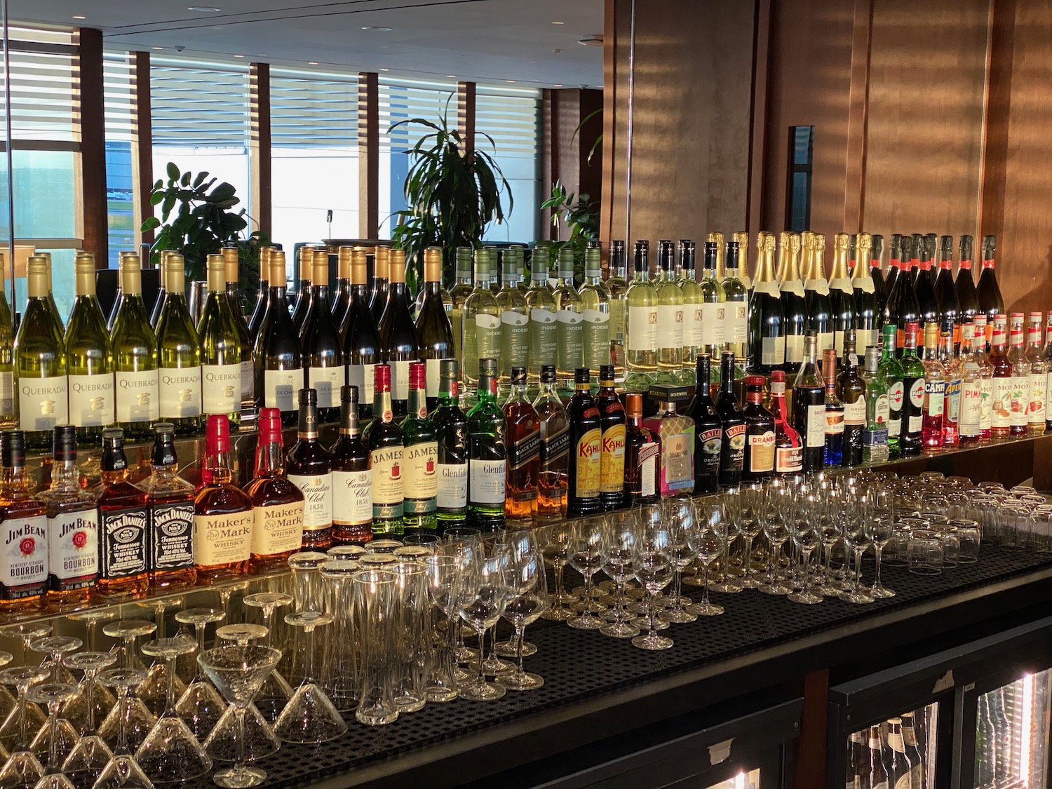 a group of bottles and glasses on a bar