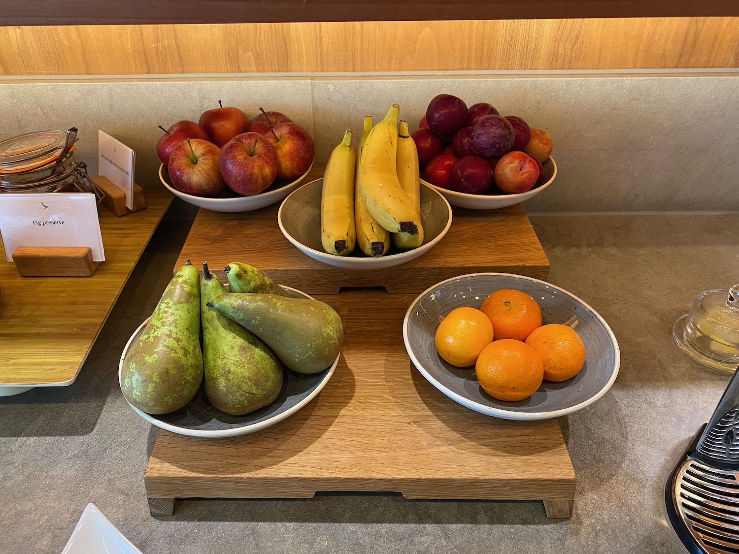a group of bowls of fruit on a wood surface