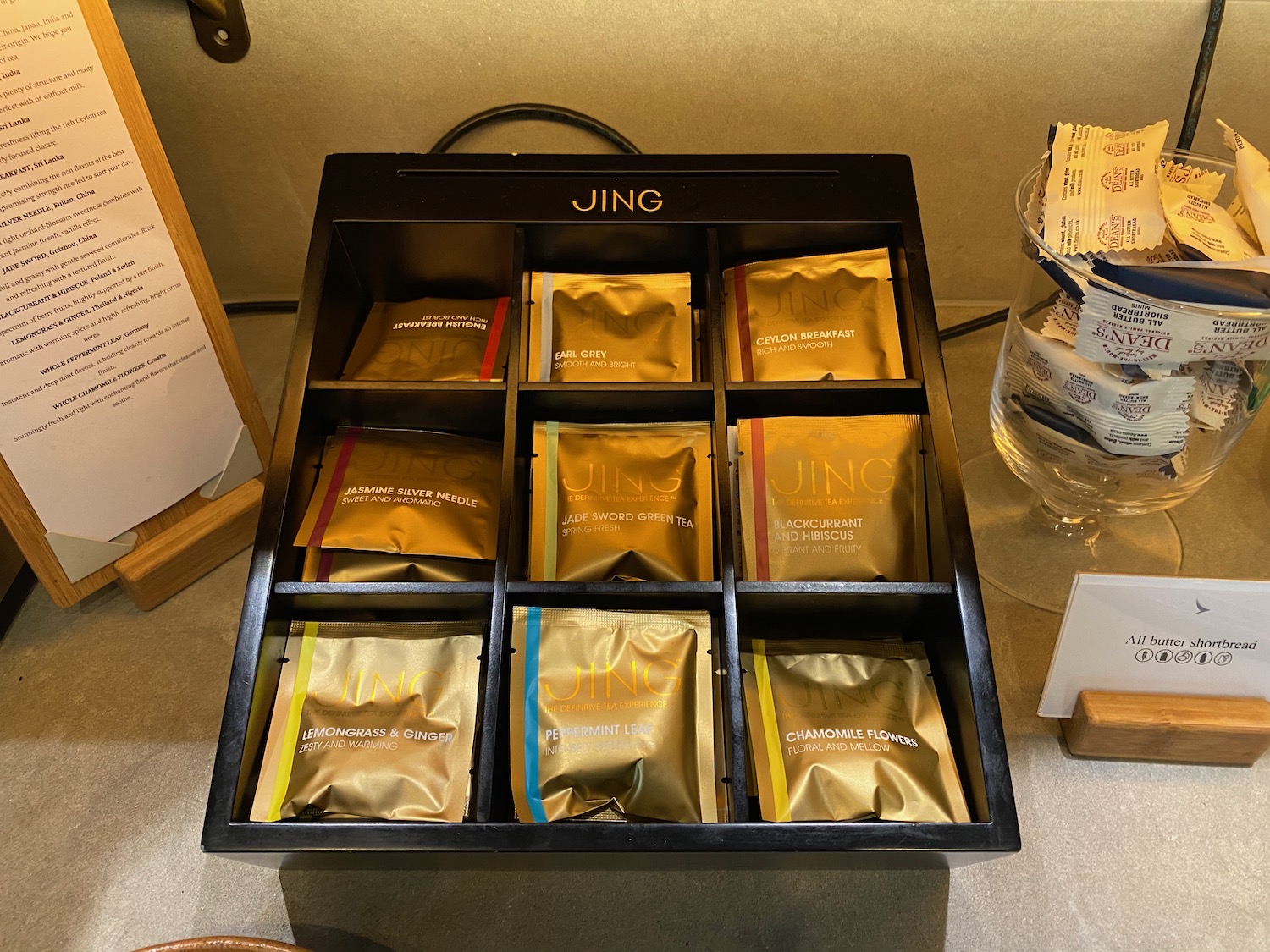a black box with gold foil packets