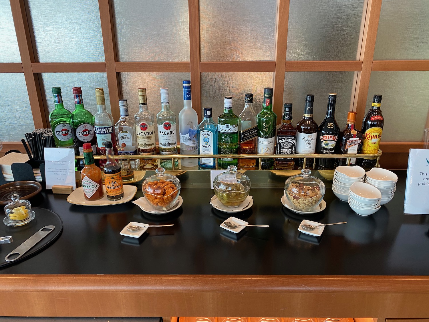 a table with bottles of liquor and bowls of food