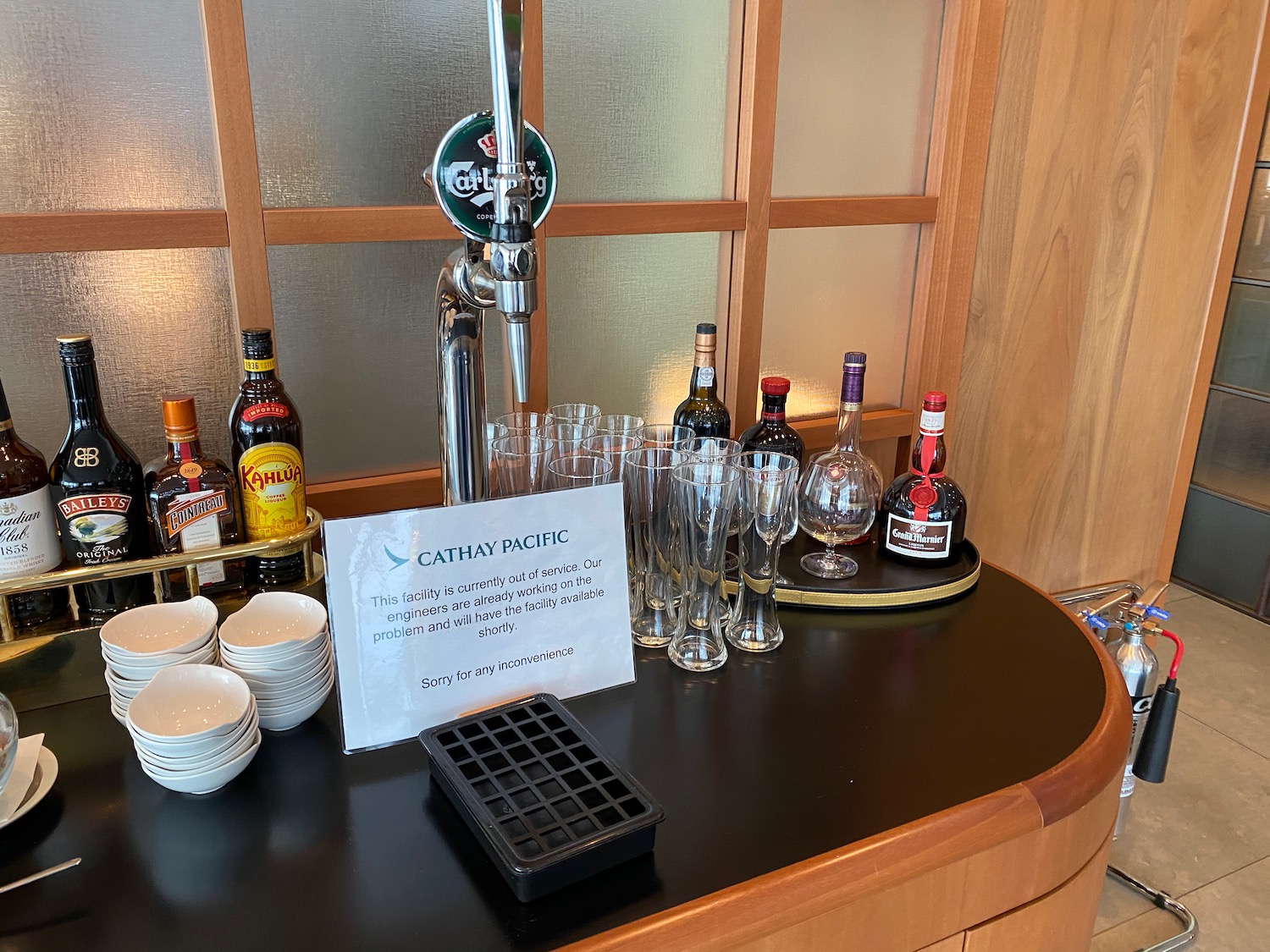 a bar with a tap and glasses and bottles