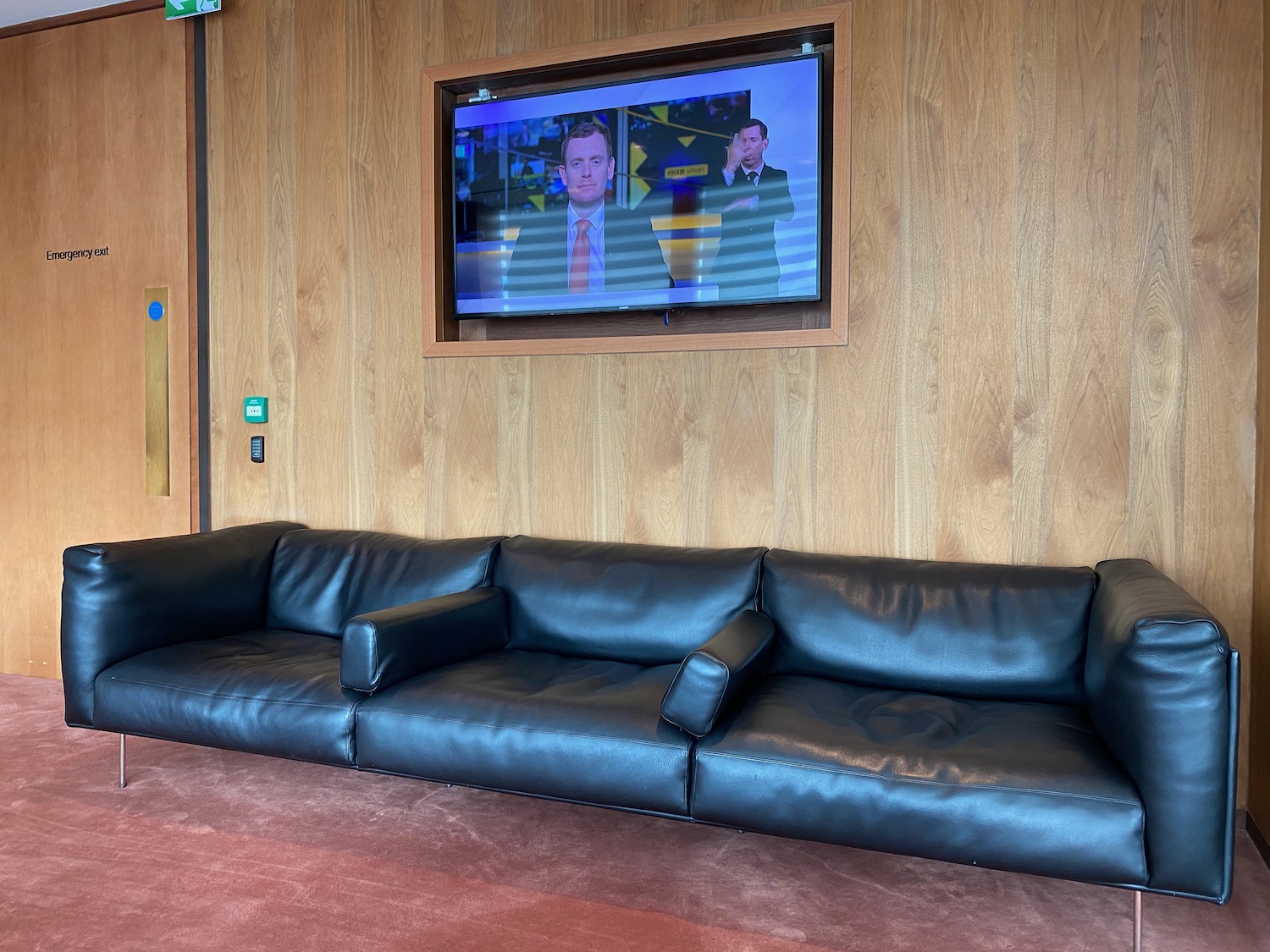 a couch in a room with a television on the wall