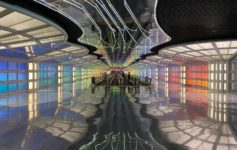 a colorful hallway with people walking in it