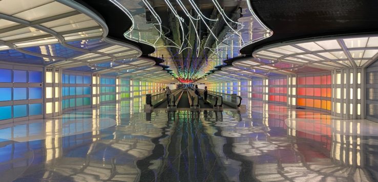 a colorful hallway with people walking in it