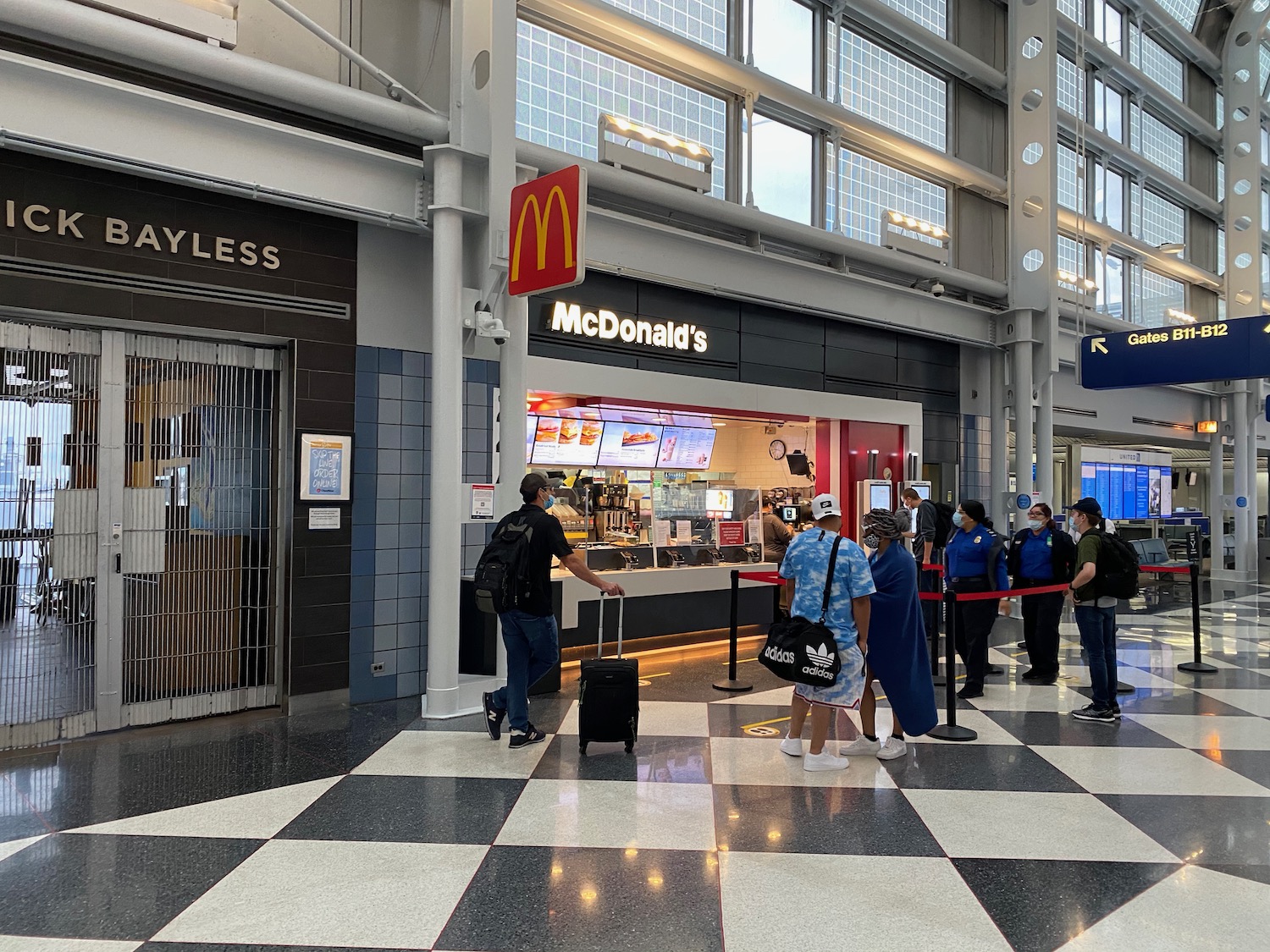 people standing in line at a fast food restaurant