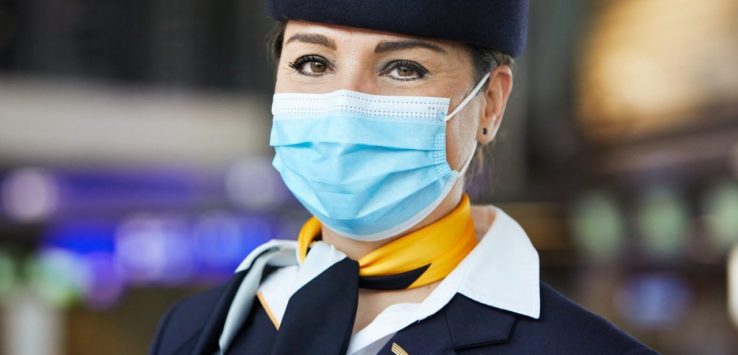 a woman wearing a mask and a hat