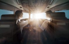 two men in the cockpit of an airplane