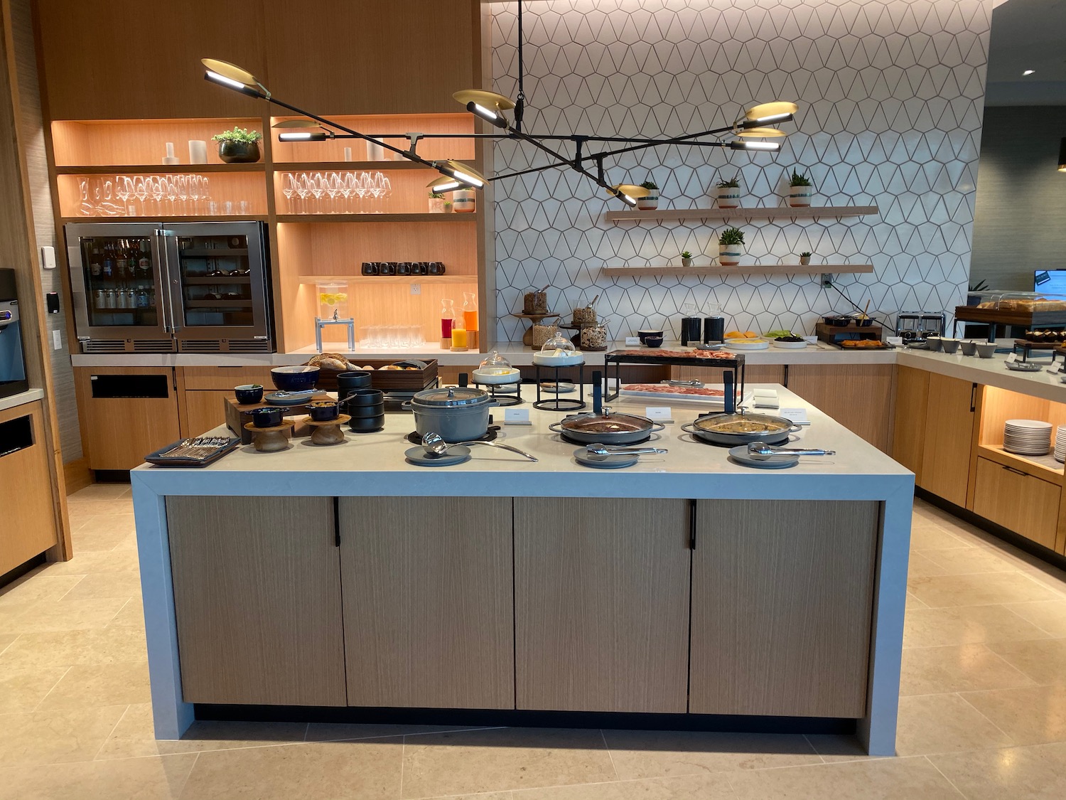 a kitchen with a large island with food on it