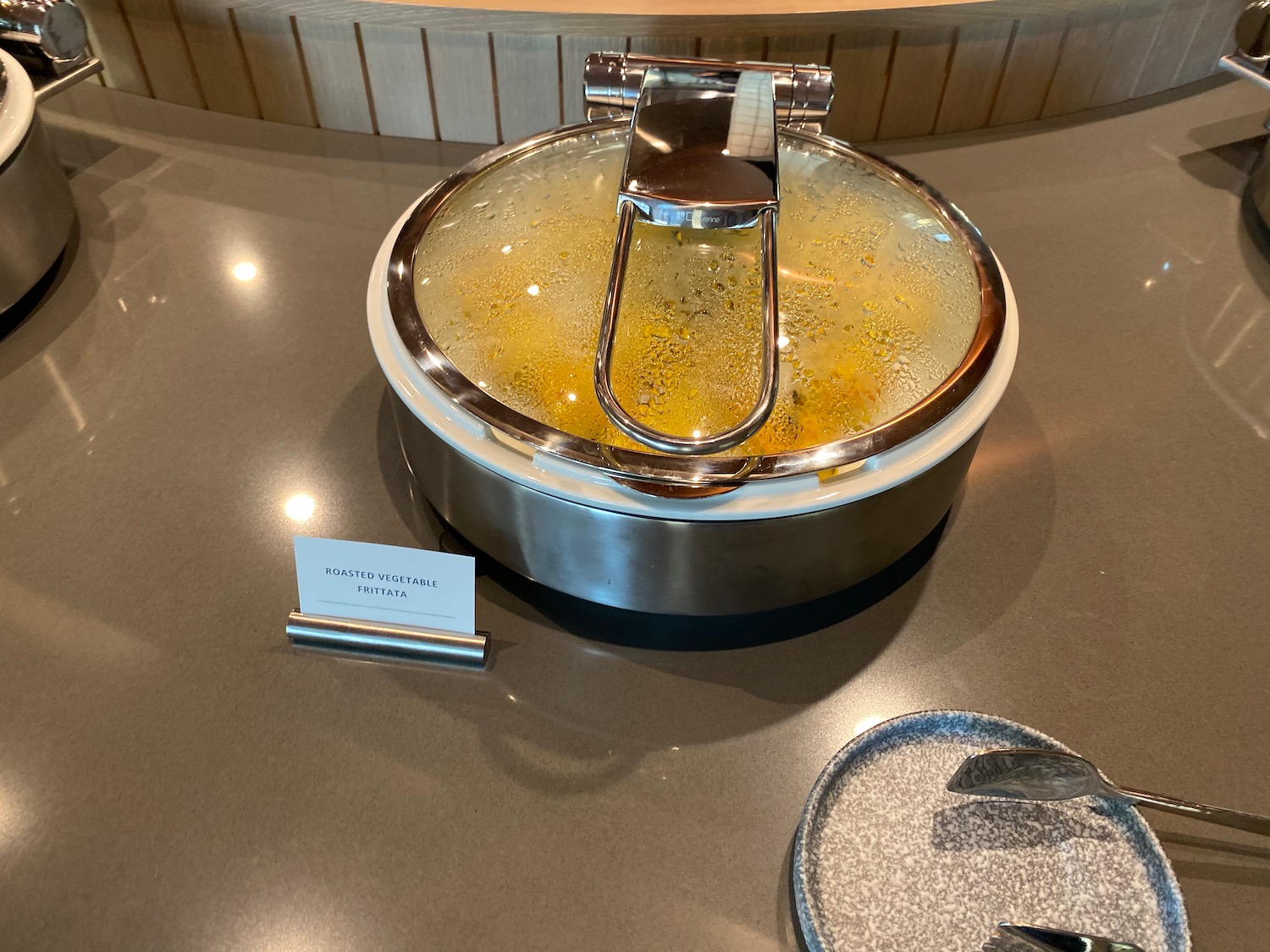 a pot with a handle and a metal lid on a counter