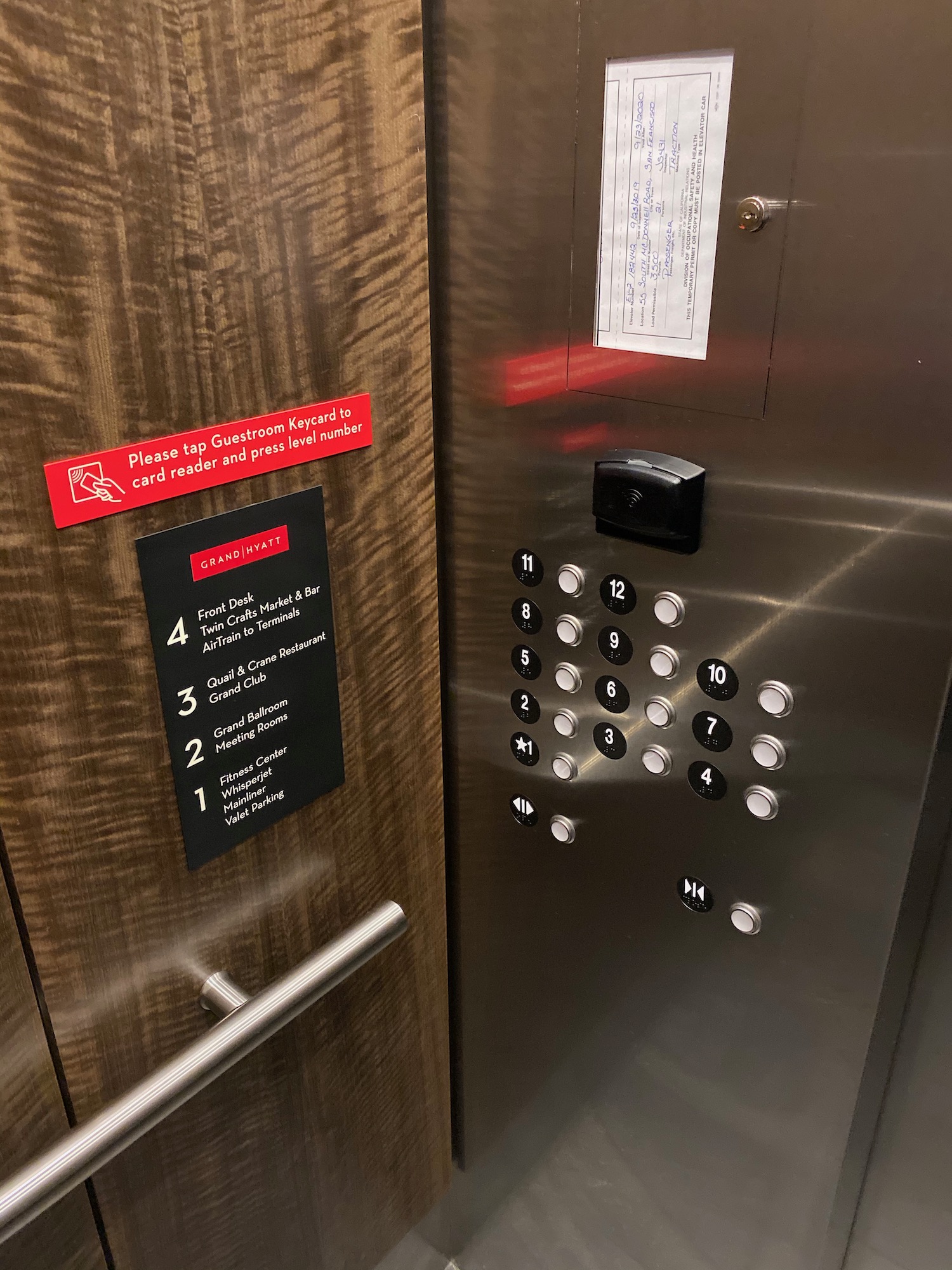 a elevator with buttons and a door handle