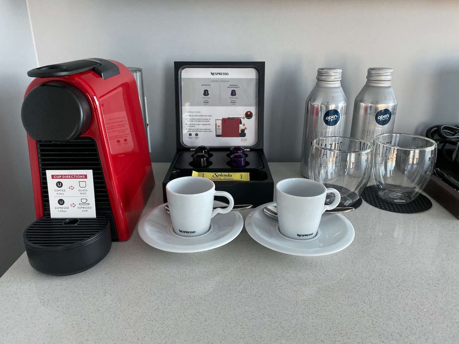 a coffee machine and cups on a table