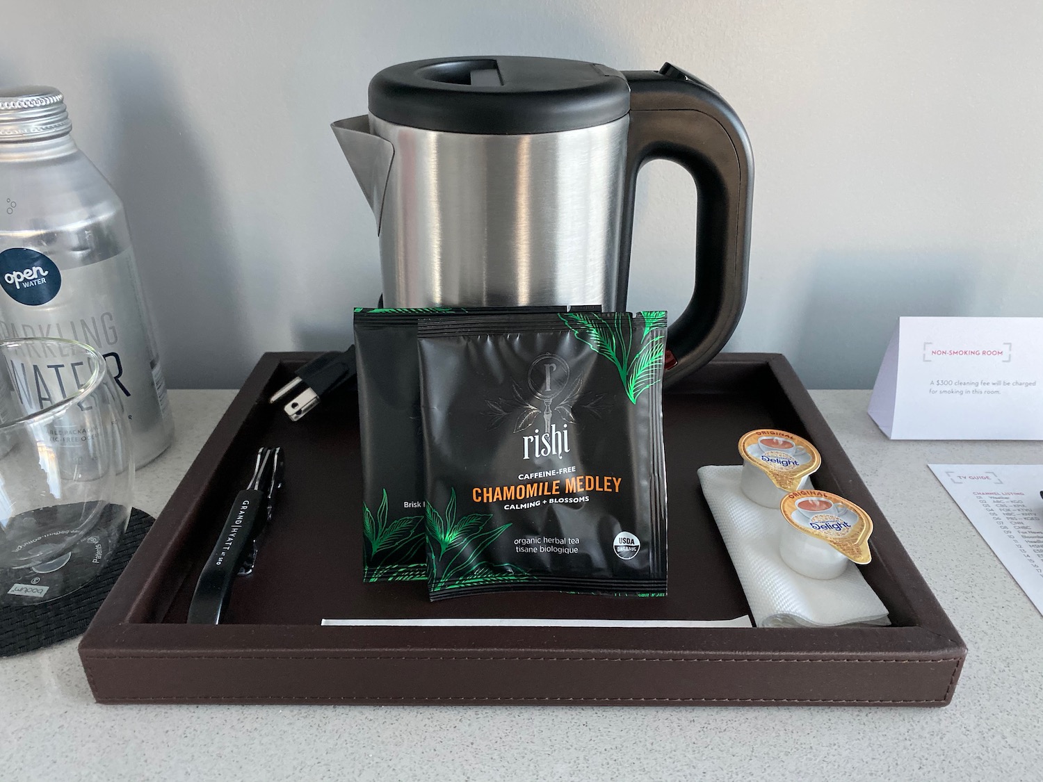 a tray with a coffee pot and a packet of tea