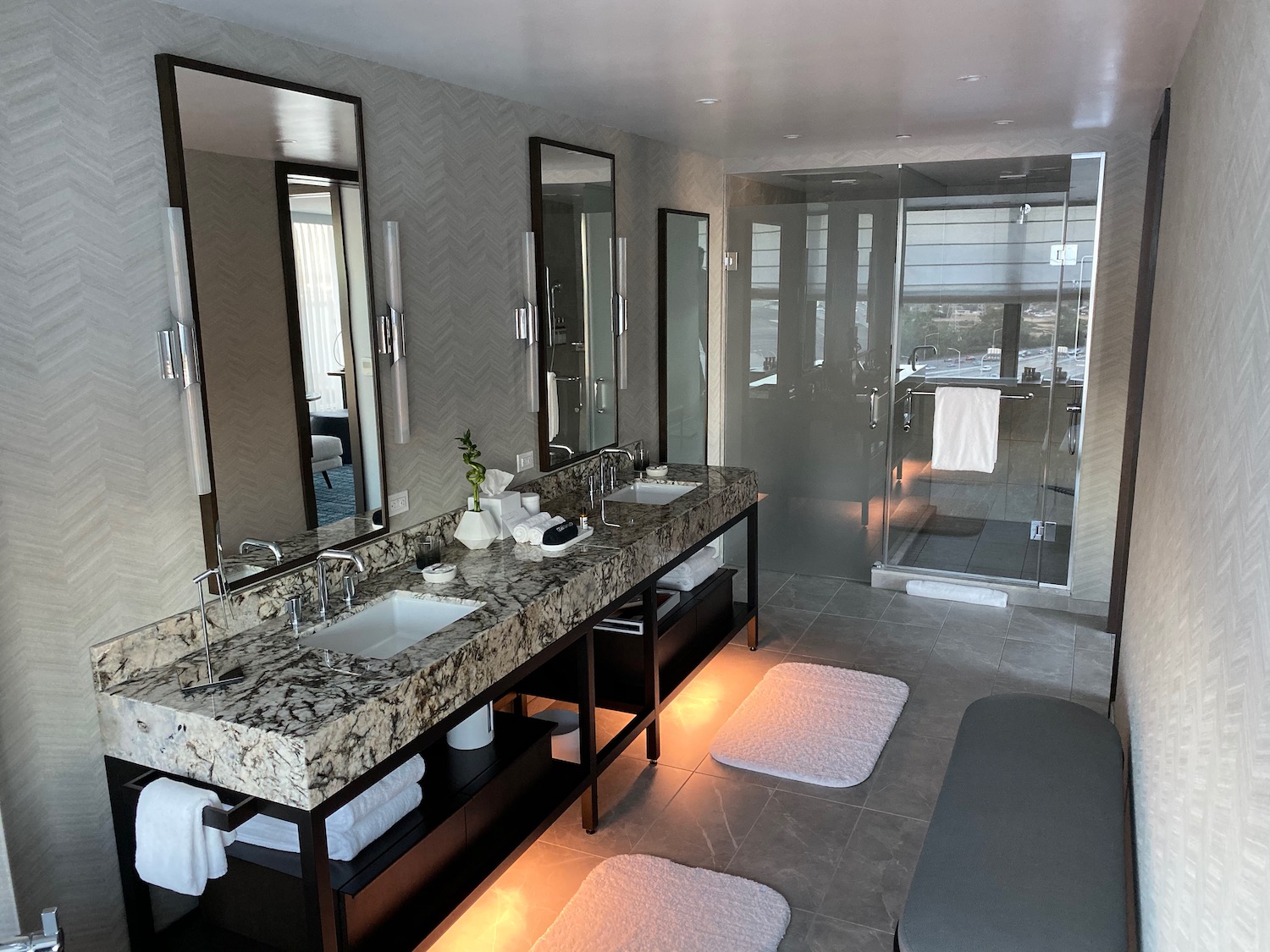 a bathroom with a marble countertop and a shower