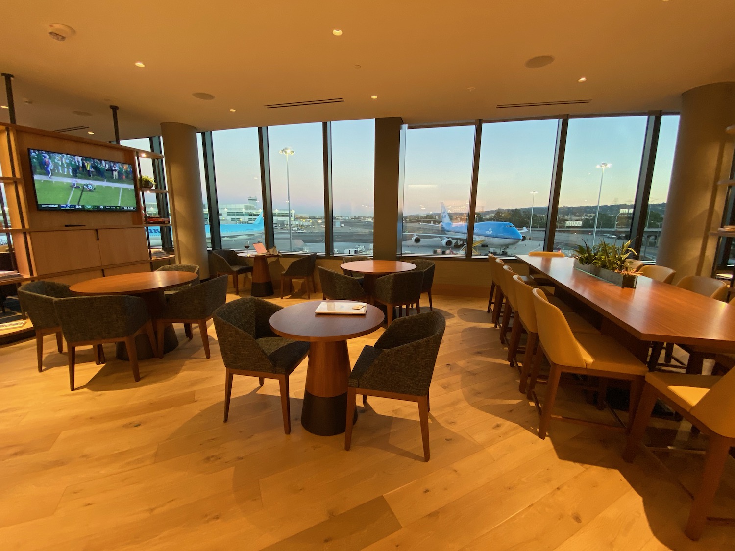 a room with tables and chairs and a large window