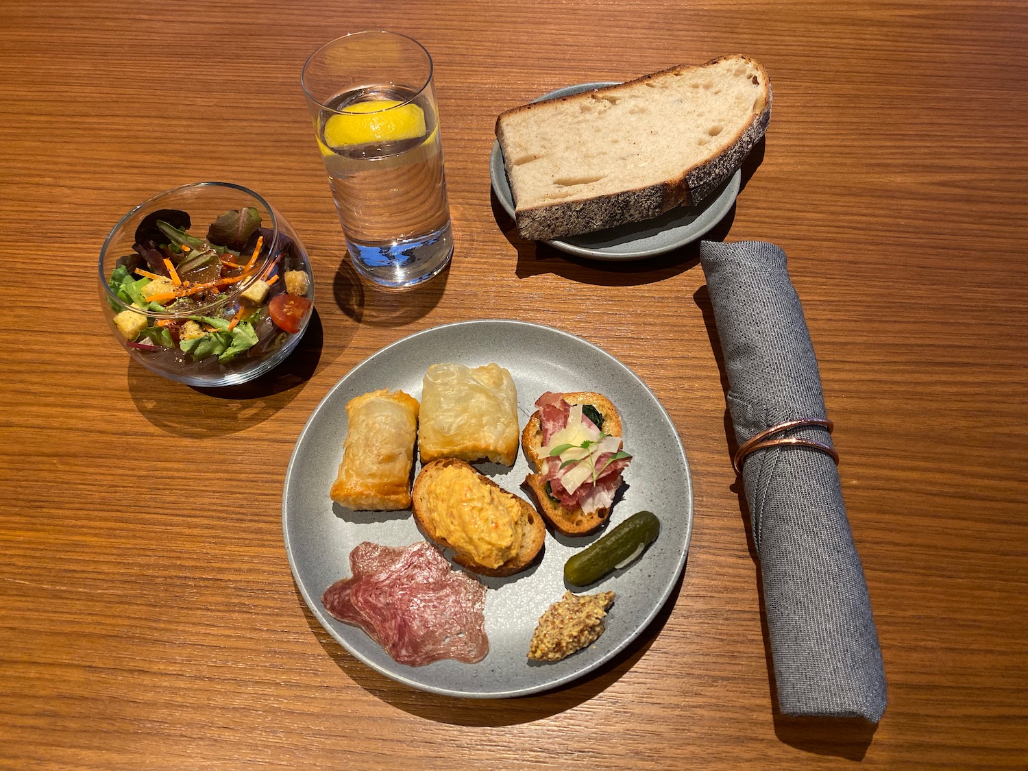 a plate of food and a glass of water on a table