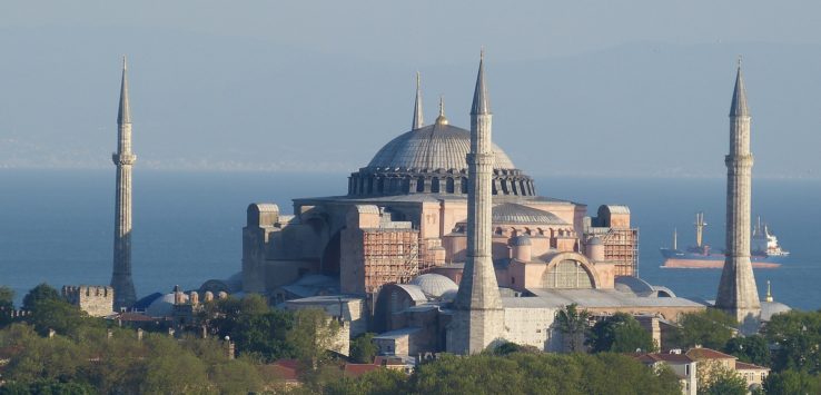 a large building with a dome and towers with Hagia Sophia in the background