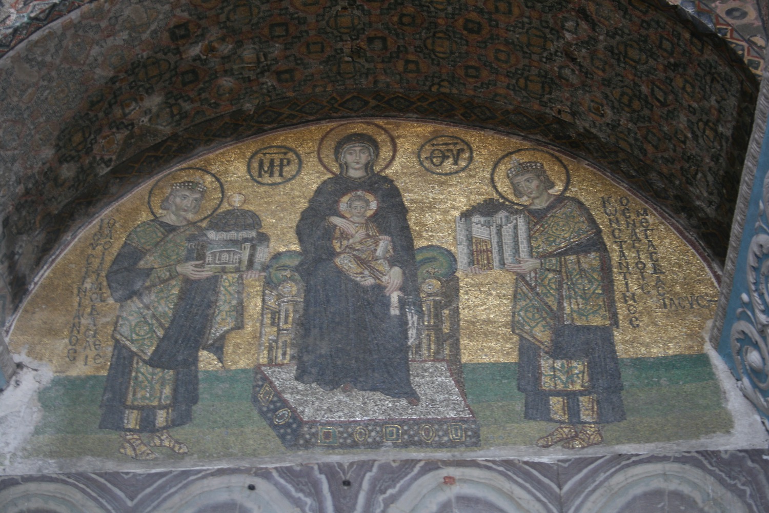a mosaic of a woman holding a baby