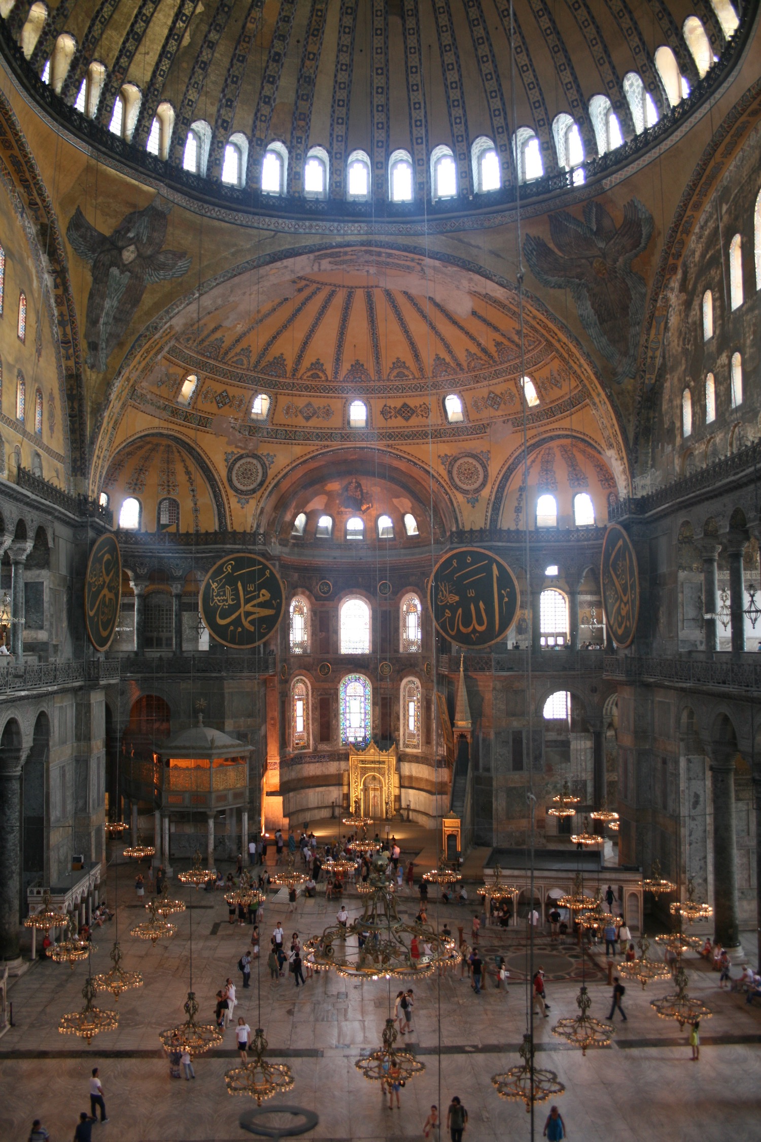 a large ornate building with many people inside with Hagia Sophia in the background