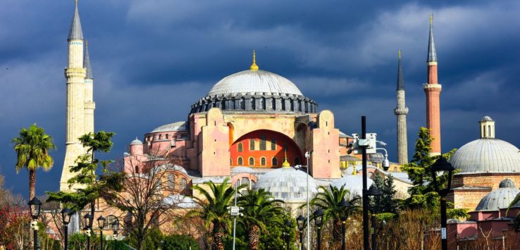 a group of people walking in front of a large building with Hagia Sophia in the background