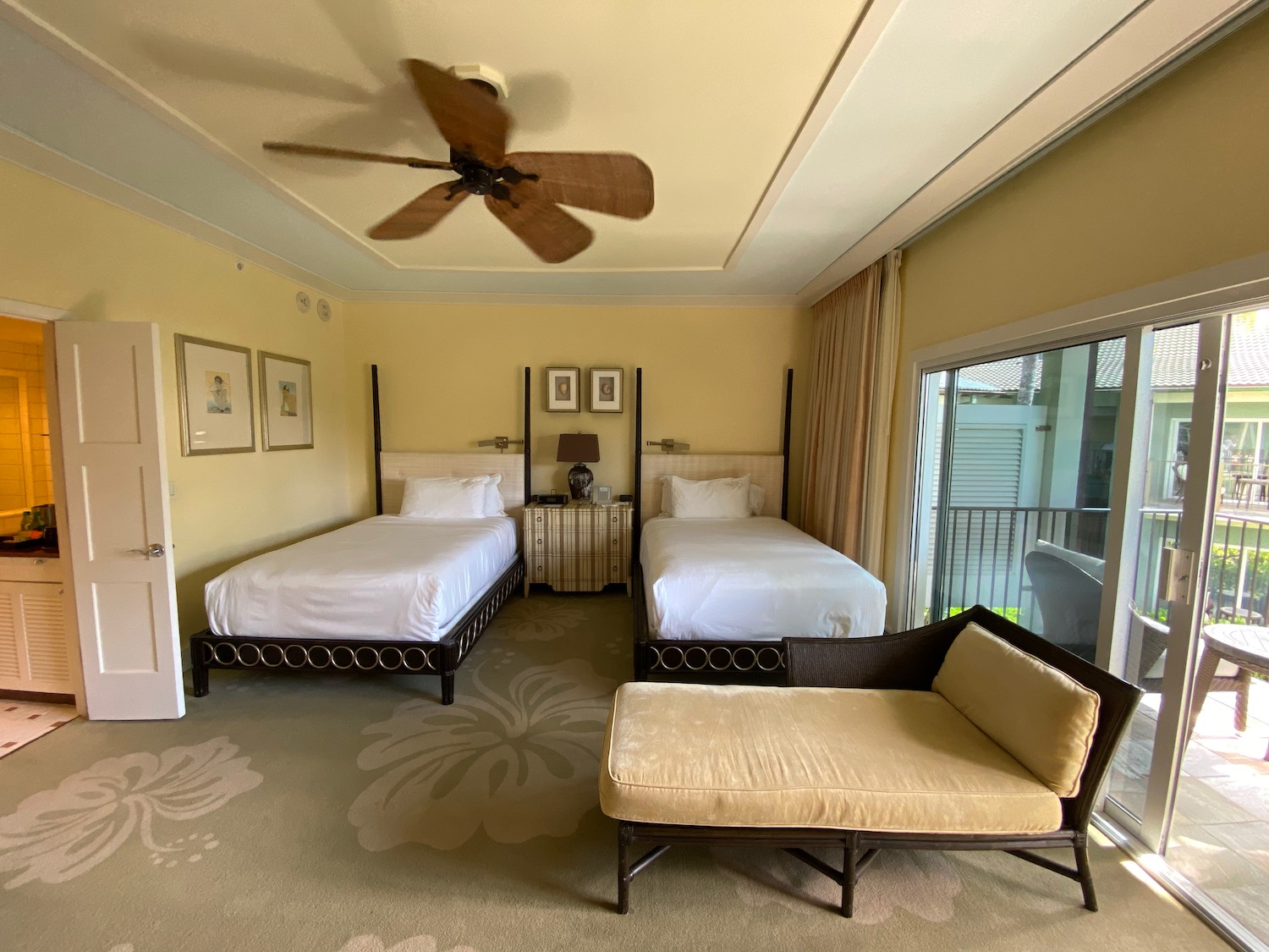 a room with two beds and a fan