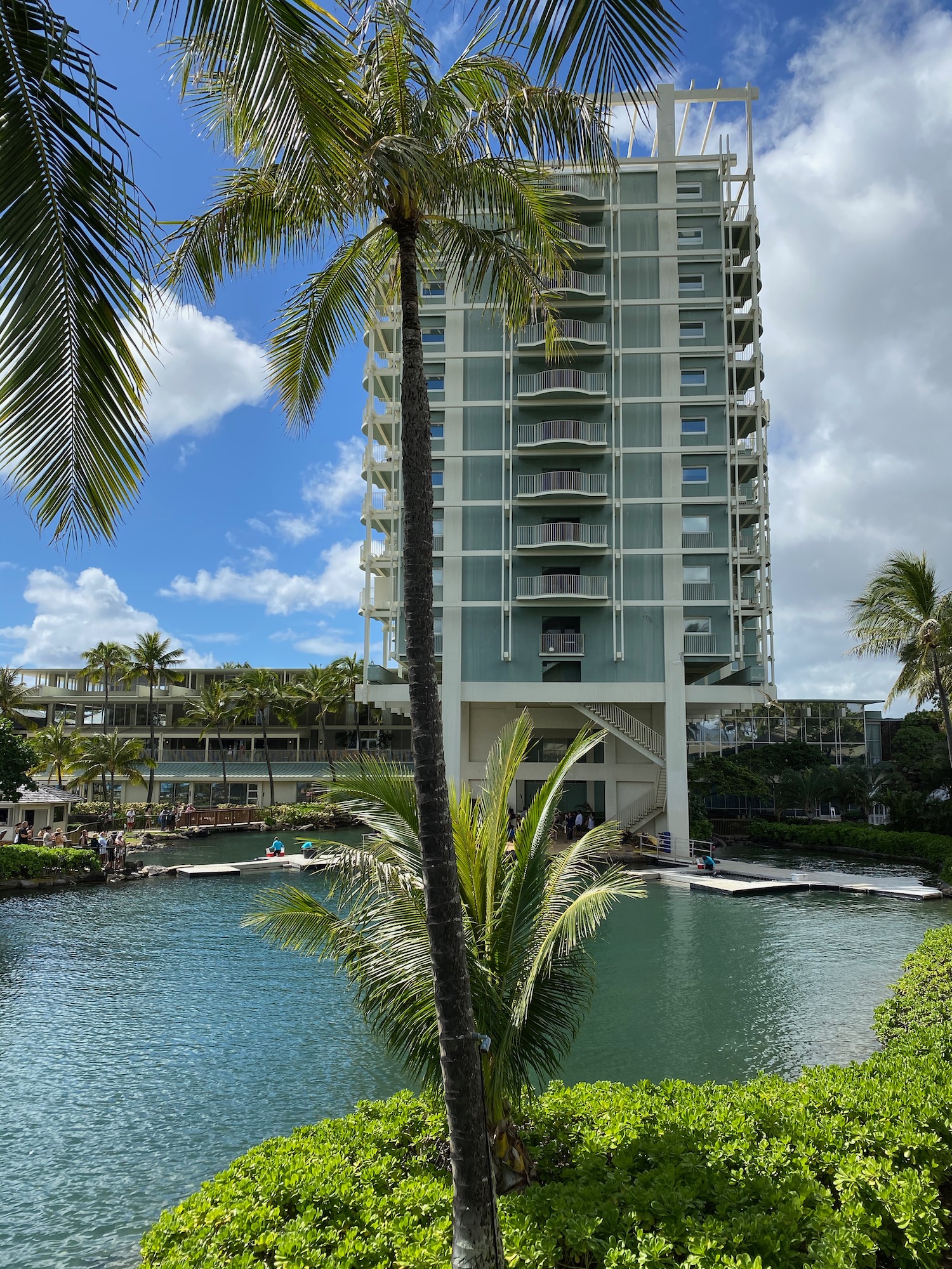 a building with a pool and palm trees