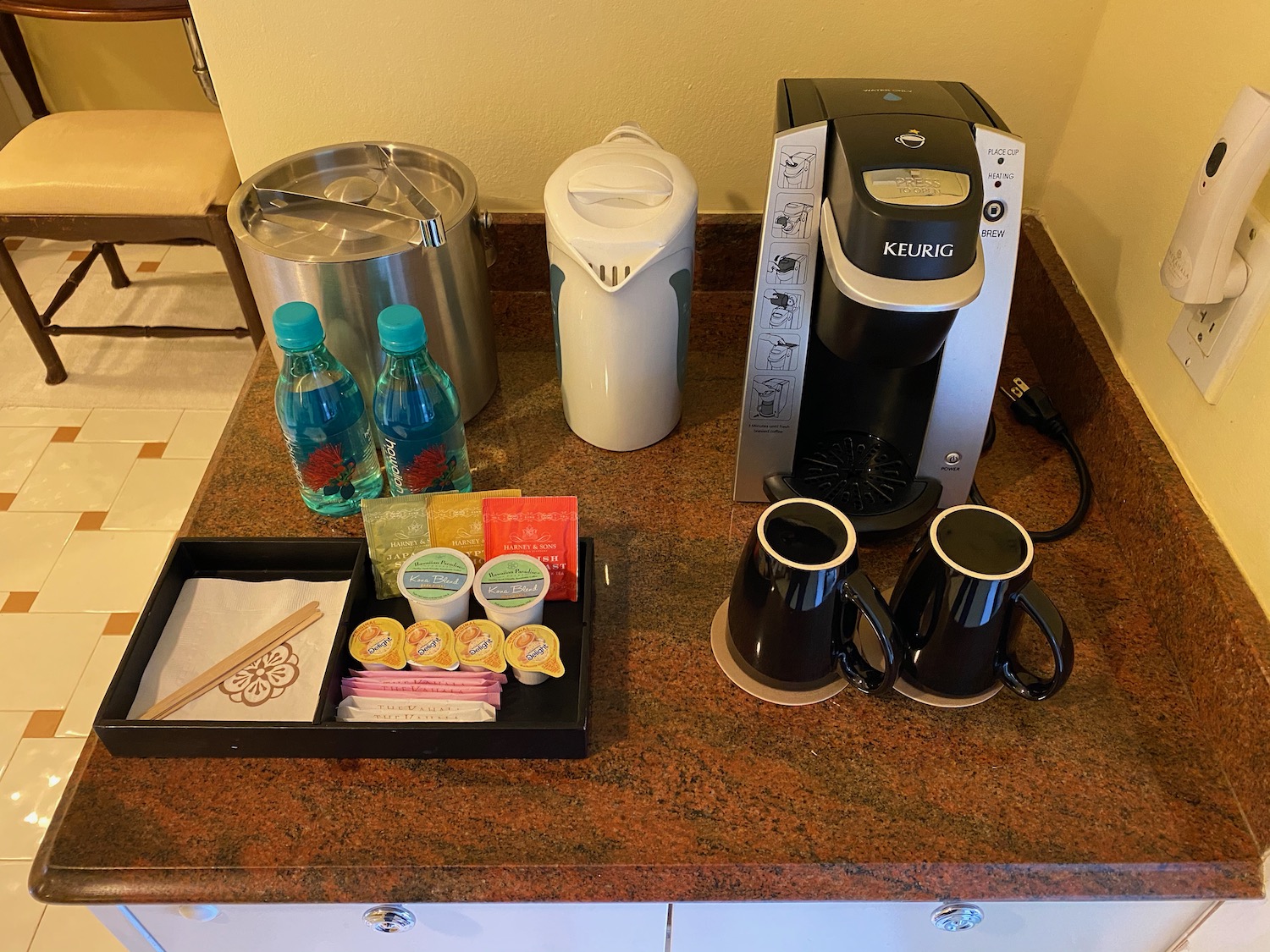 a coffee maker and coffee cups on a counter